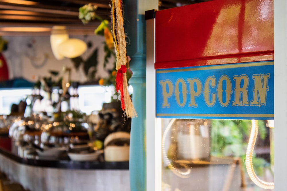 closeup photo of blue and red popcorn popping machine