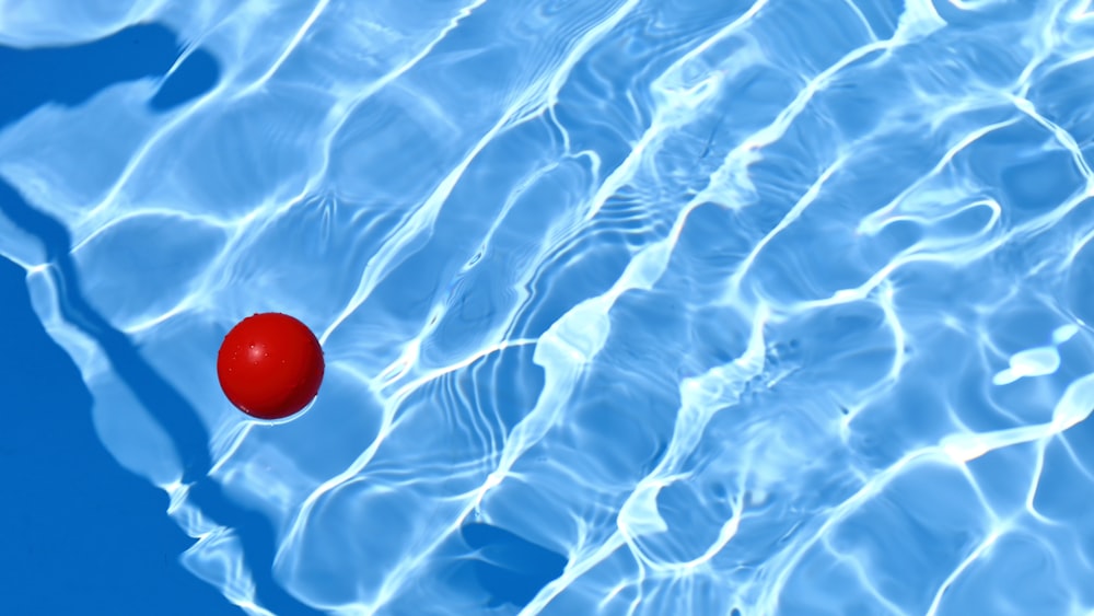 red ball in body of water