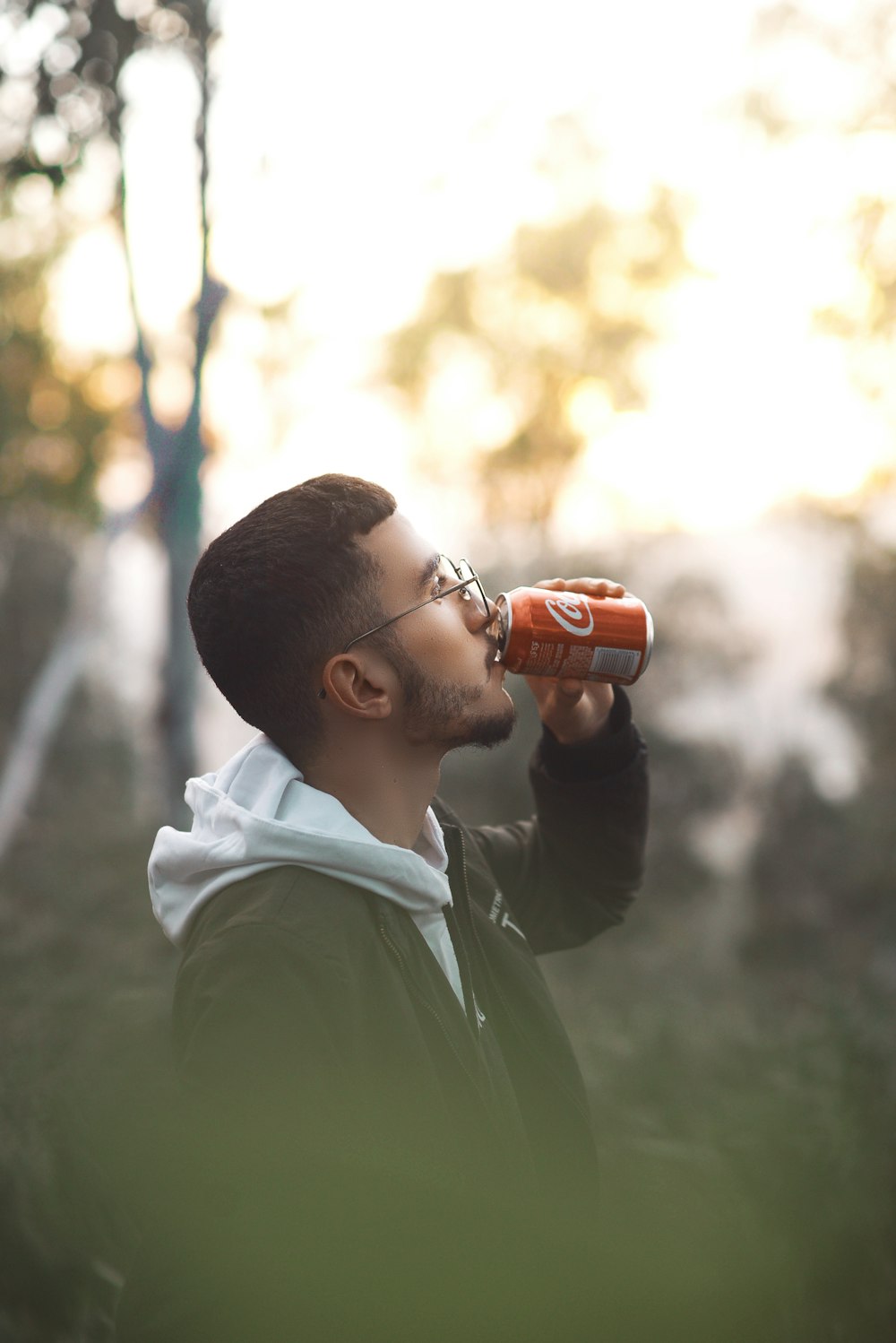 man drinking Coke can