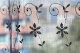 Artisan’s hands weaving fine lace threads with Florence’s Ponte Vecchio softly blurred in the background.