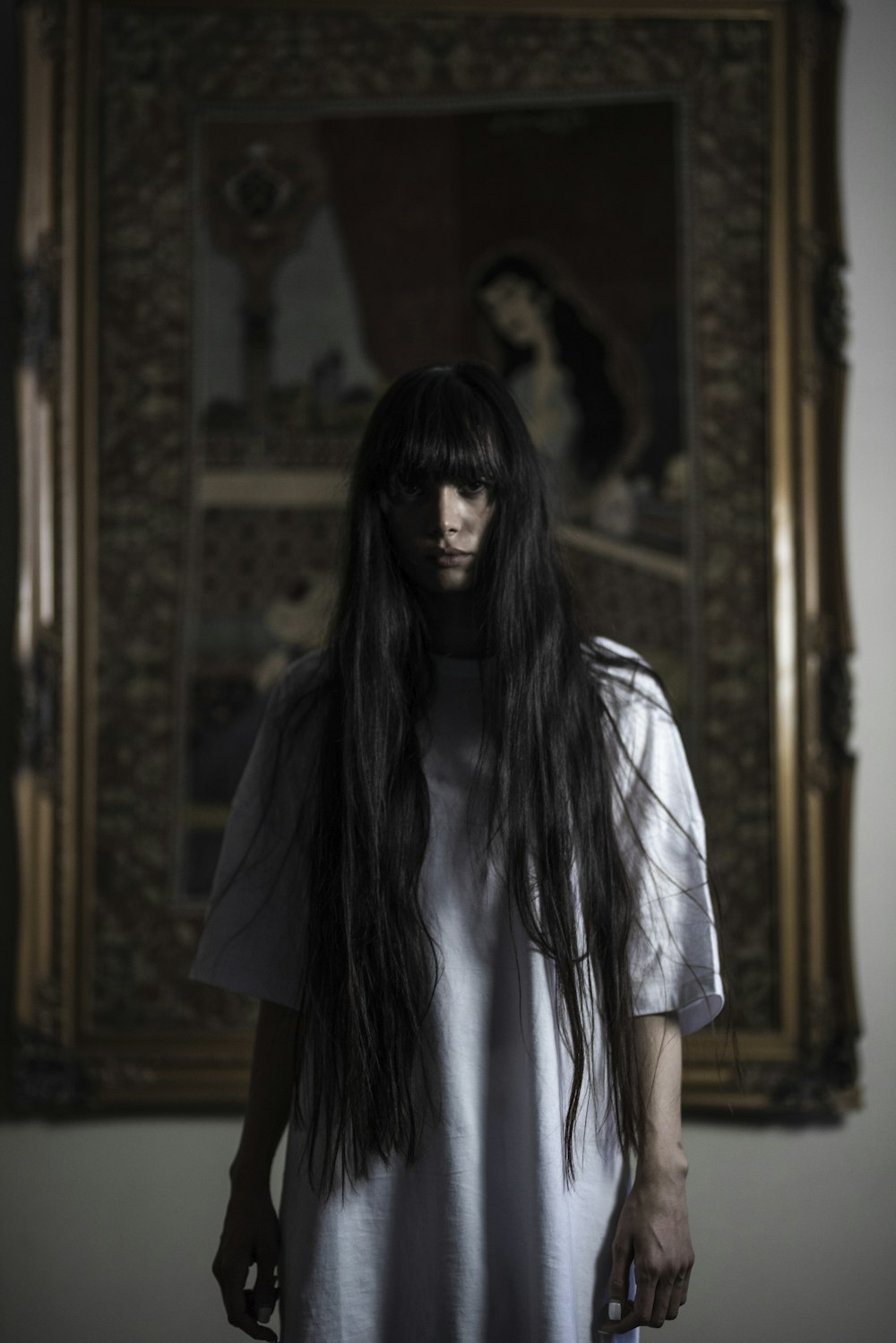 woman standing in front of painting on wall