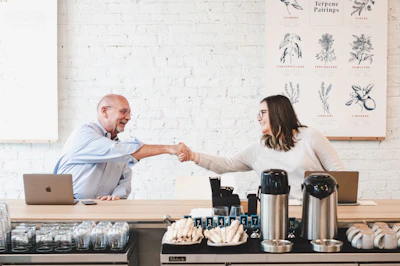 A friendly Bionovax representative discussing partnership opportunities with a reseller over coffee.