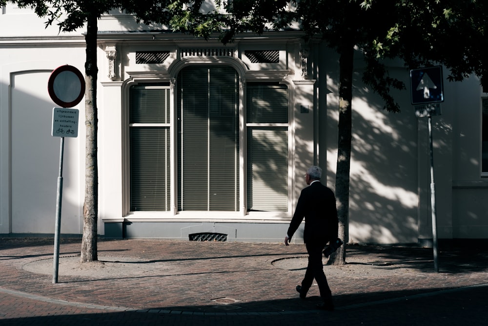 man walking near tree