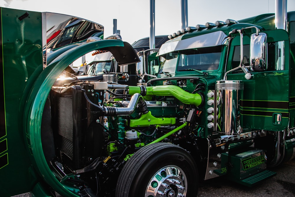 a close up of the front of a green semi truck