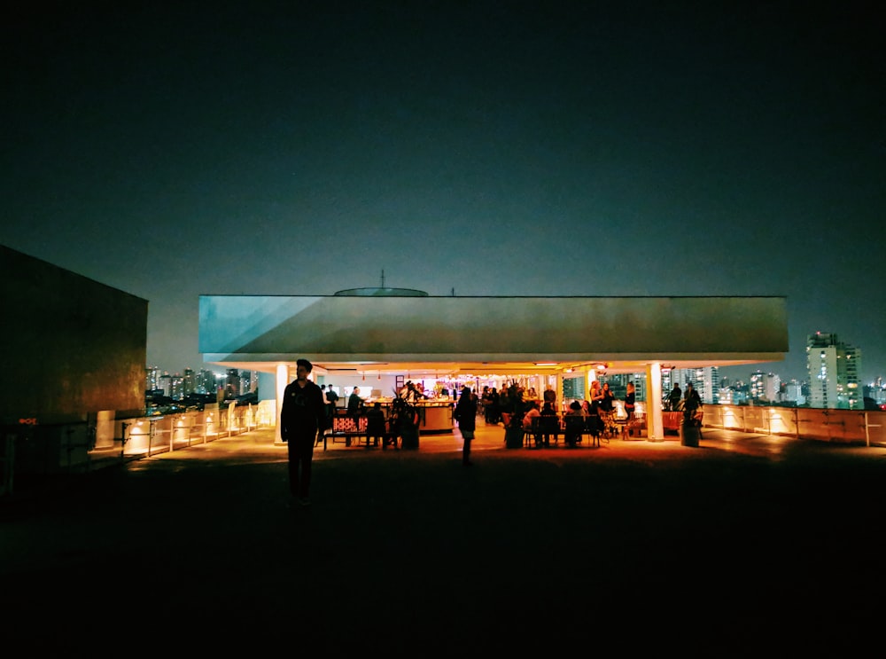 people gathering on brown shed