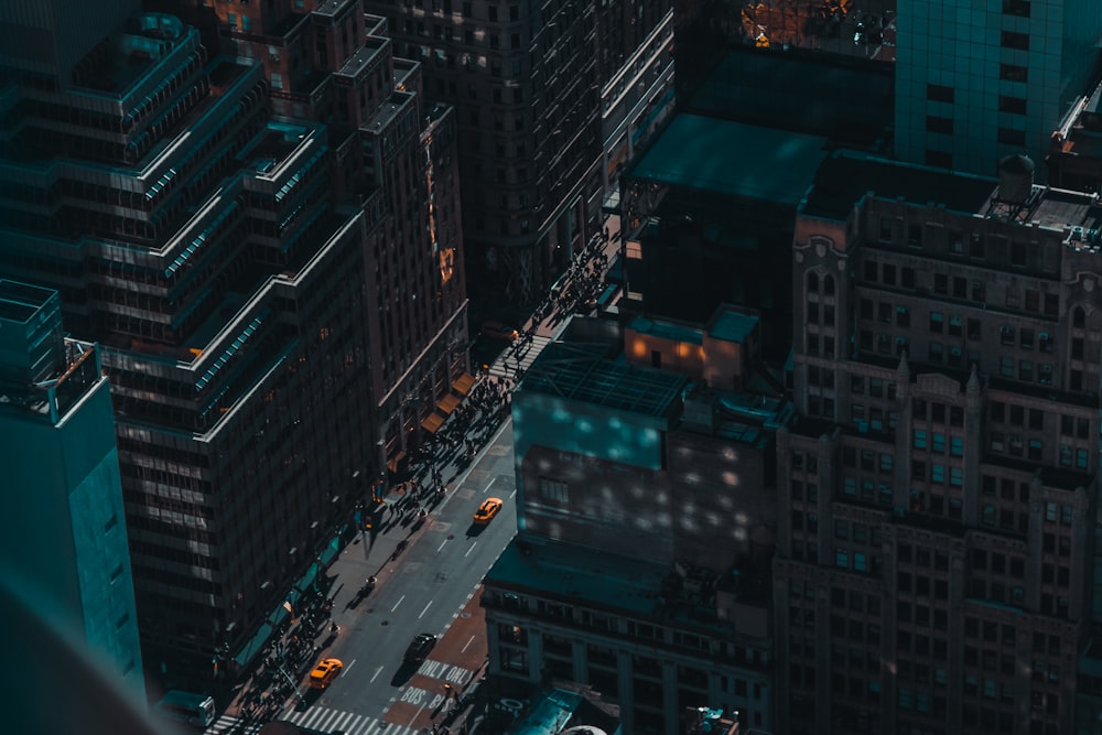 different vehicles on road beside high-rise building during night time