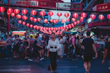 A vibrant street scene from a bustling Asian market at dusk.