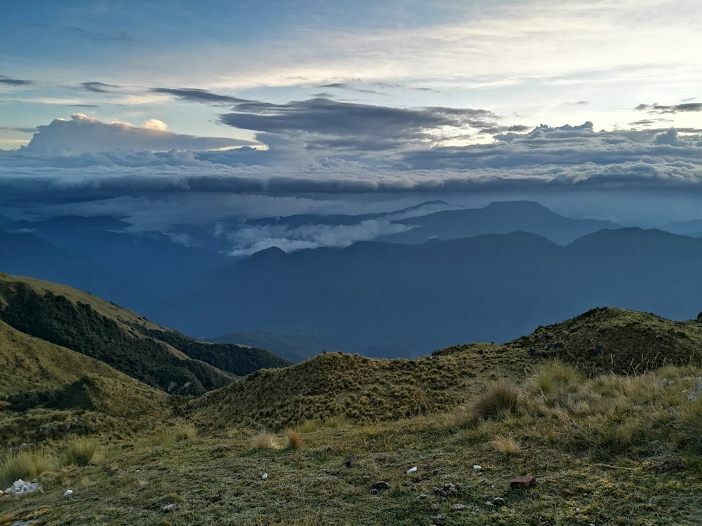 brown and gray mountains under white clouds