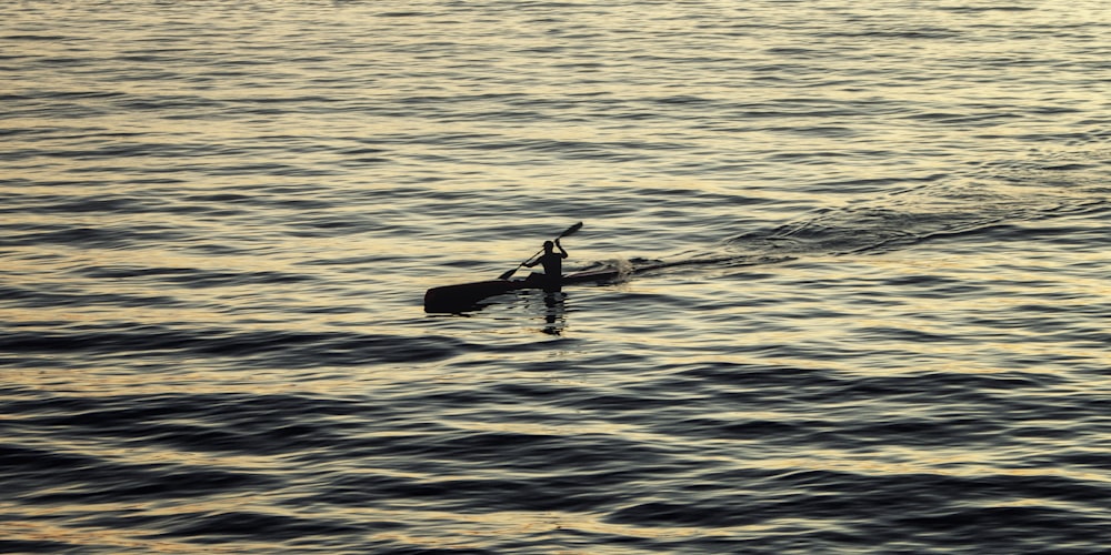 man on boat on body of water