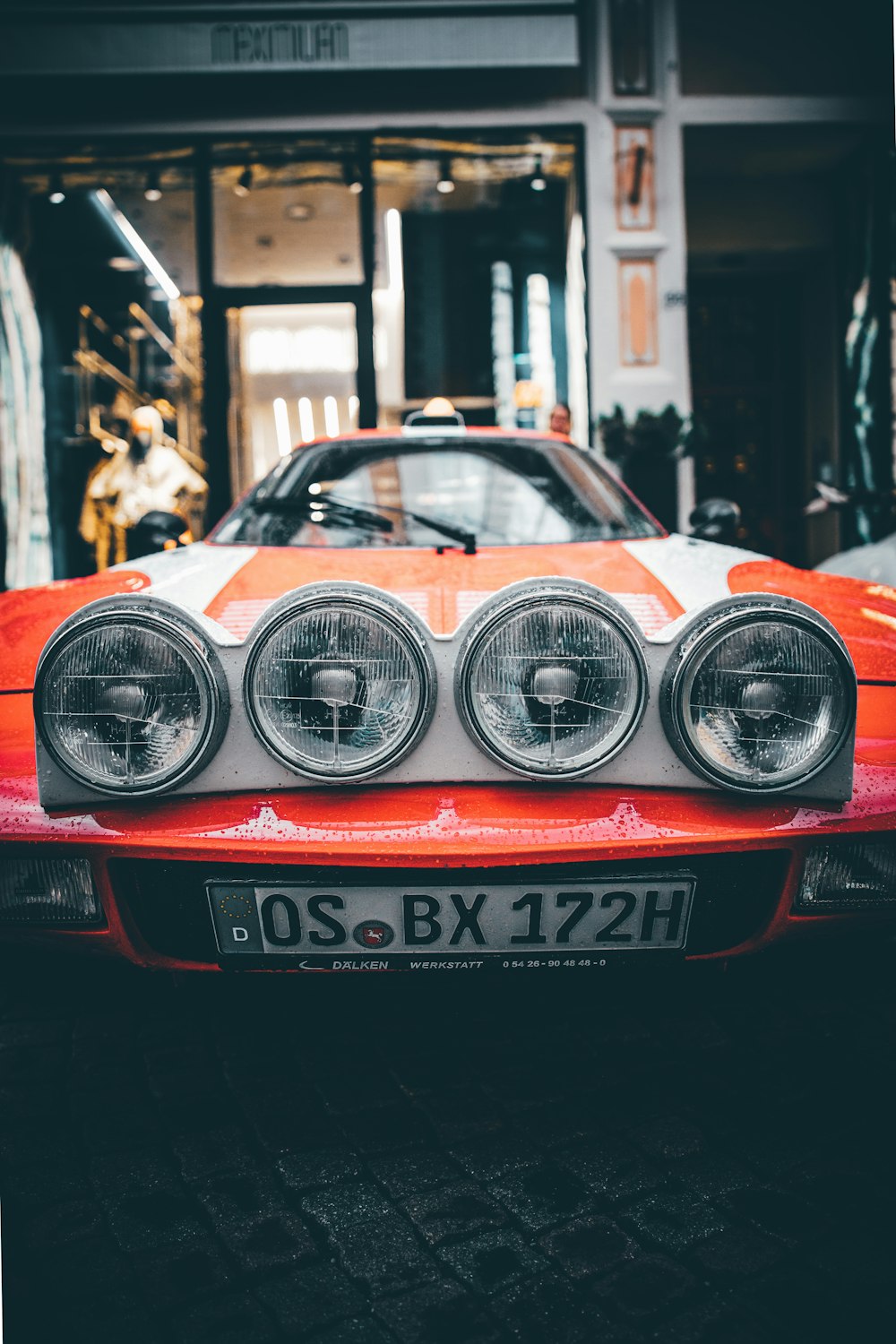 Coche rojo al lado del edificio