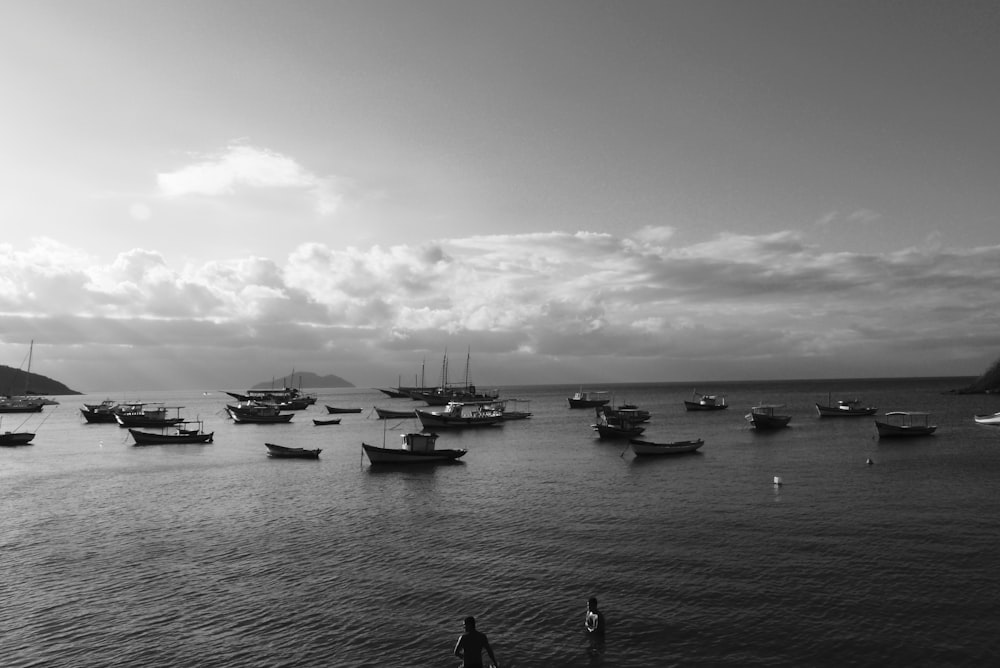 grayscale photo of boats on sea
