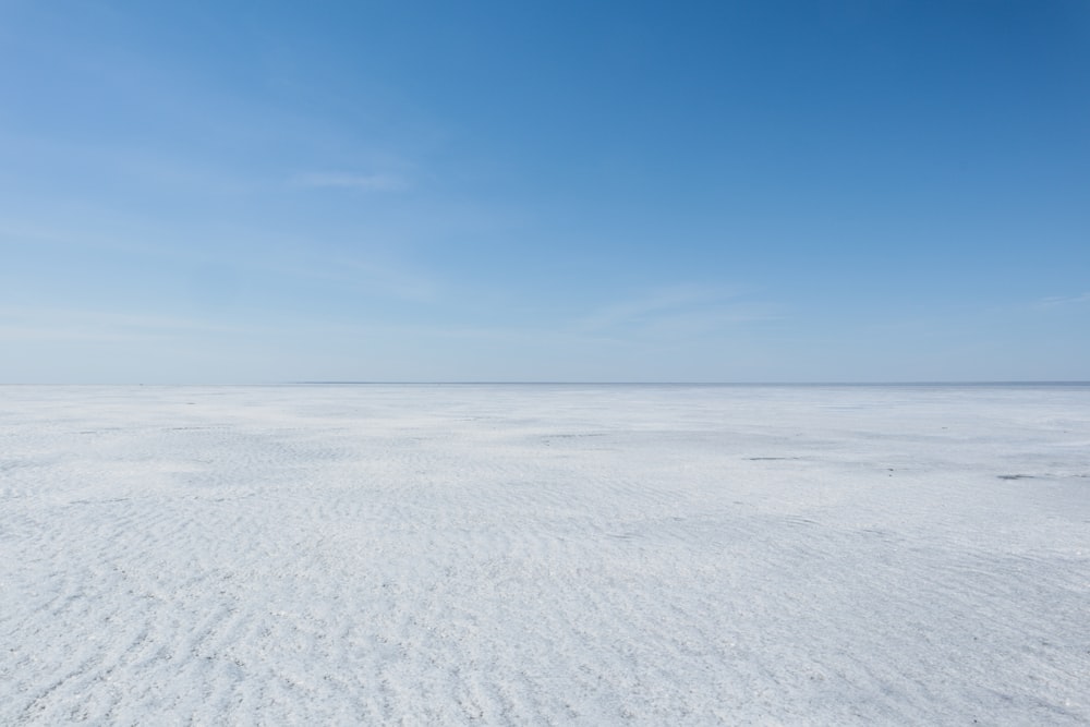 a vast expanse of white sand under a blue sky