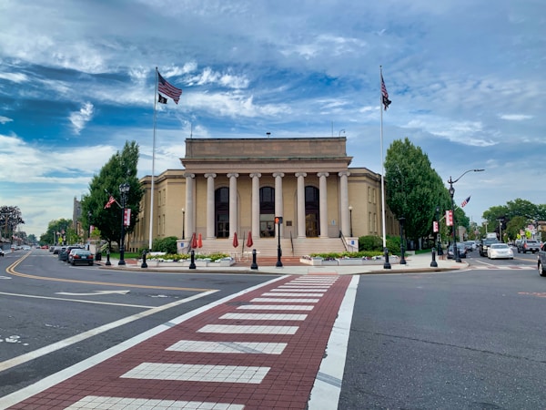 Massachusetts municipal building with columns and American flags representing local government records management