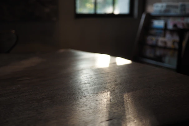 Soft natural light streaming through a window onto a desk filled with creative projects.