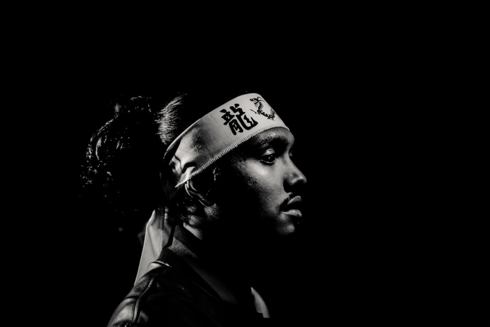 grayscale photo of man wearing white bandana