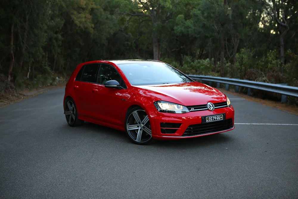 red 5-door hatchback park on road