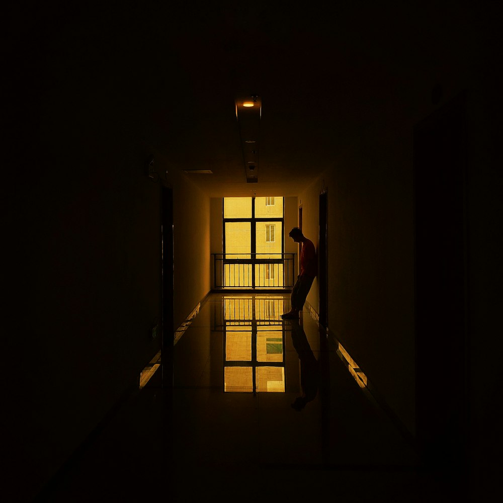man standing beside doorway