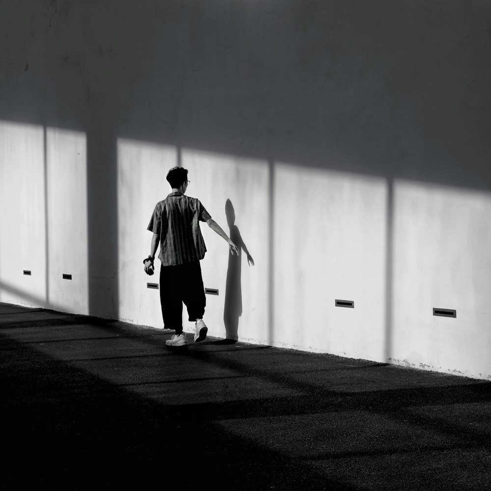 man standing beside wall