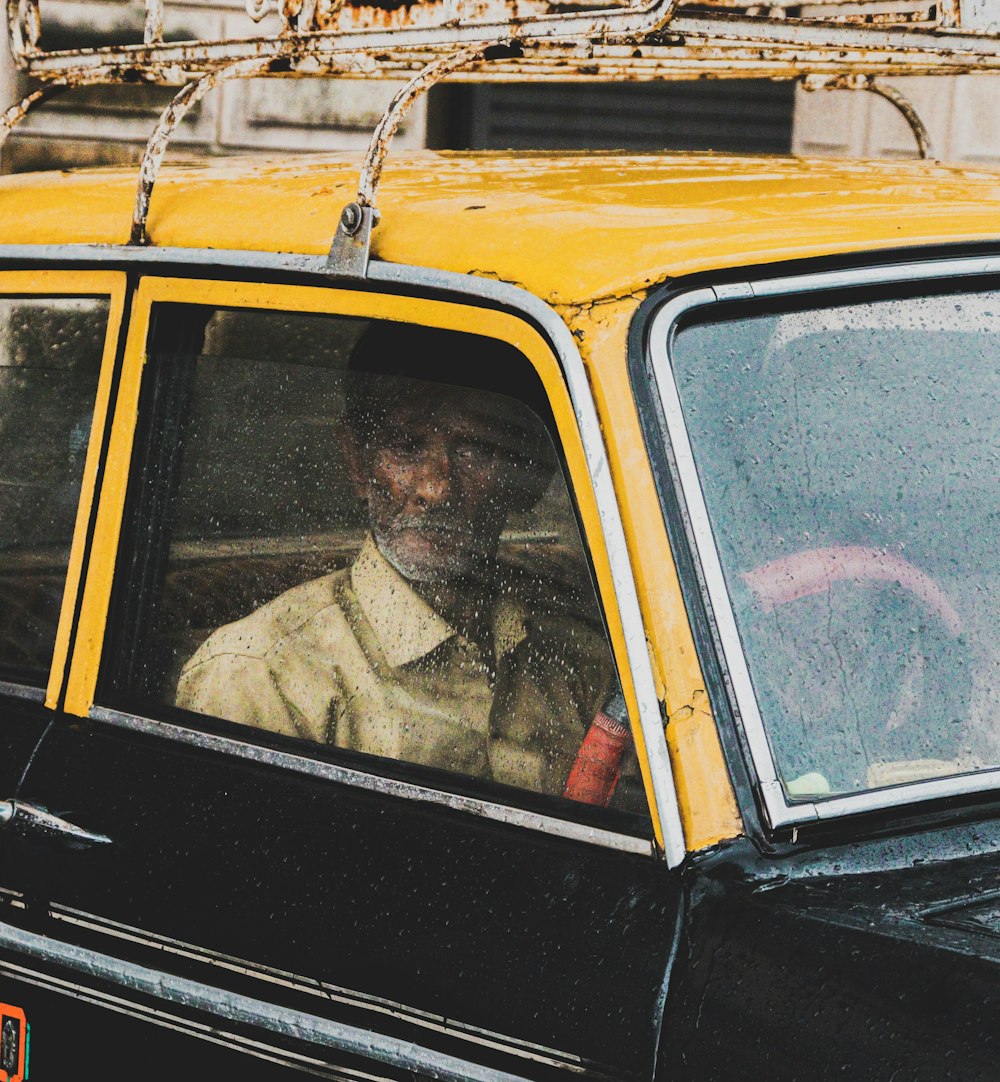 man in yellow and black vehicle