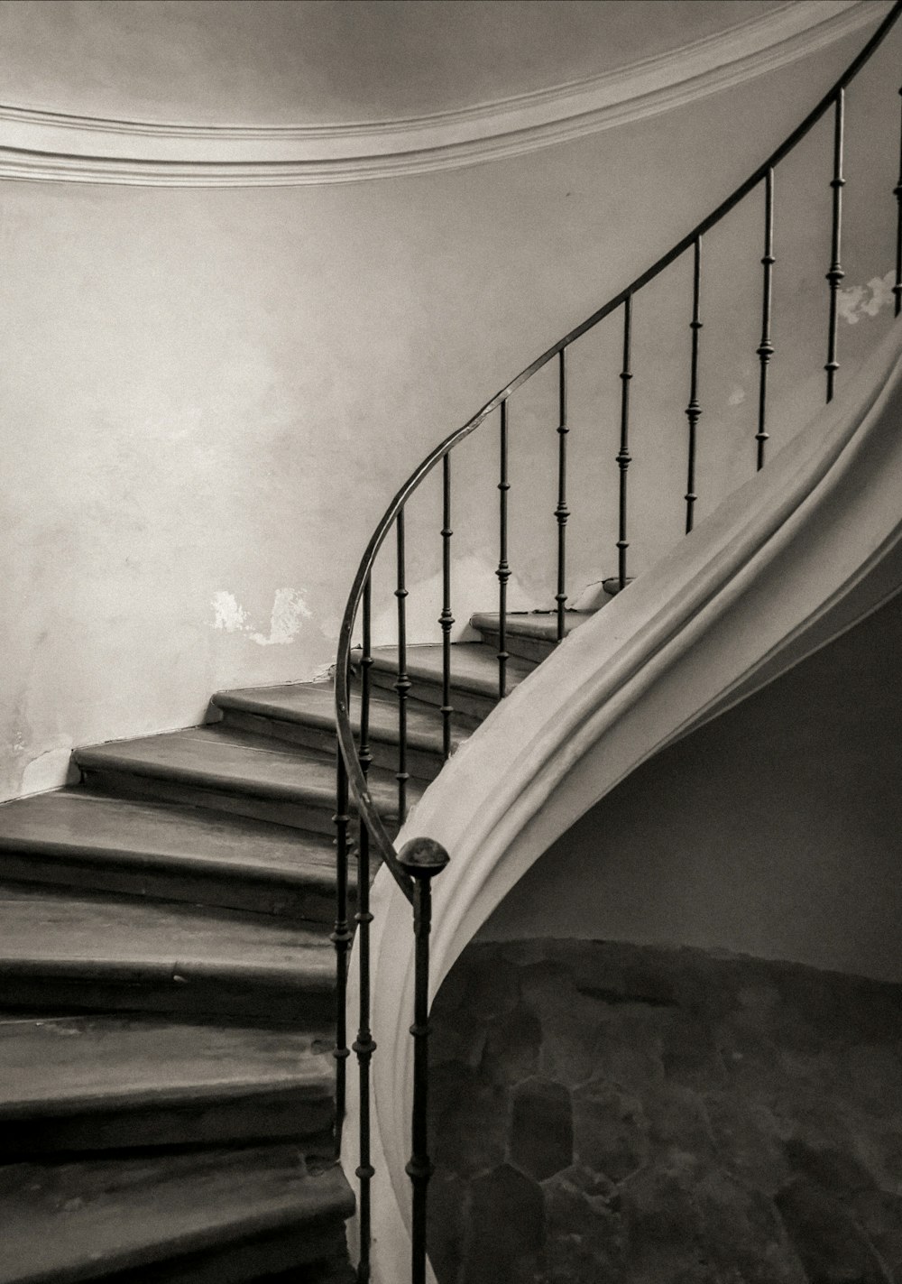 grayscale photo of spiral stairs