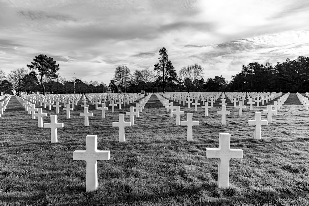 cross on graveyard grayscale photo