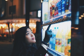 woman pointing on vending machine