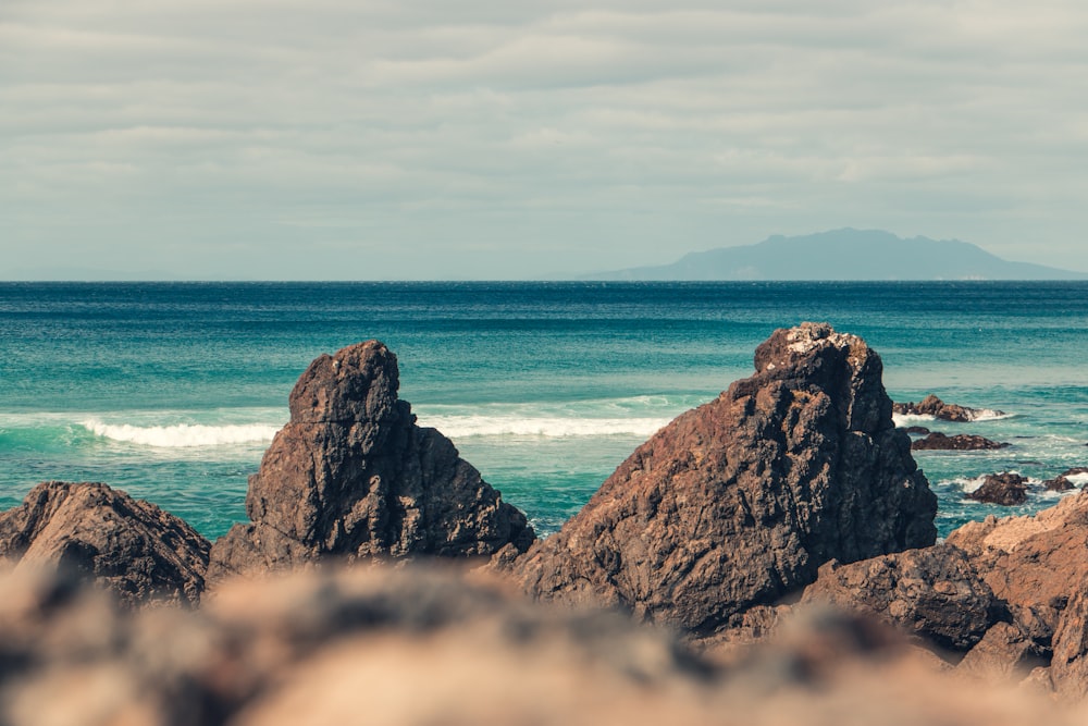 brown rocks beside body of waer