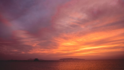 A picturesque sunset over an island, highlighting vibrant colors.