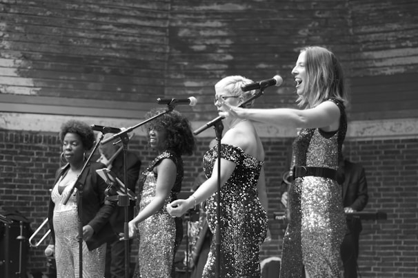 A diverse group of singers performing on stage with passion.