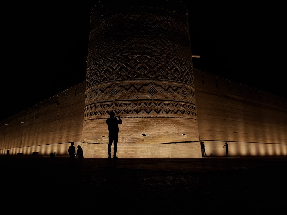 people standing near building during night