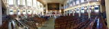 A lively club meeting taking place in the hall’s spacious main room with members engaged in discussion.