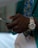 Close-up of a person wearing a sleek smart ring on their finger.