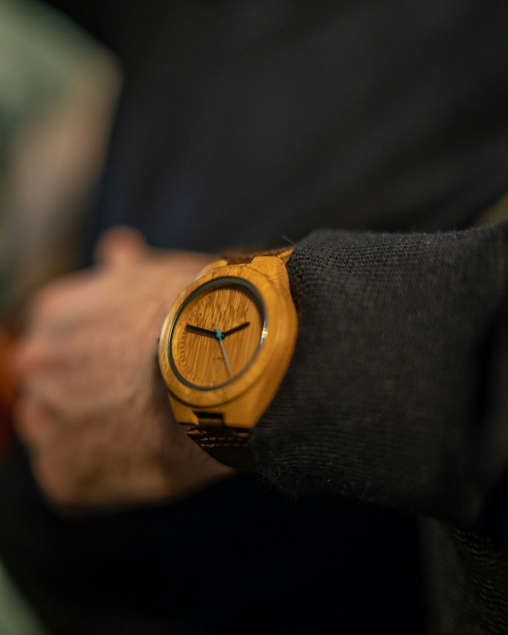 person wearing brown analog watch