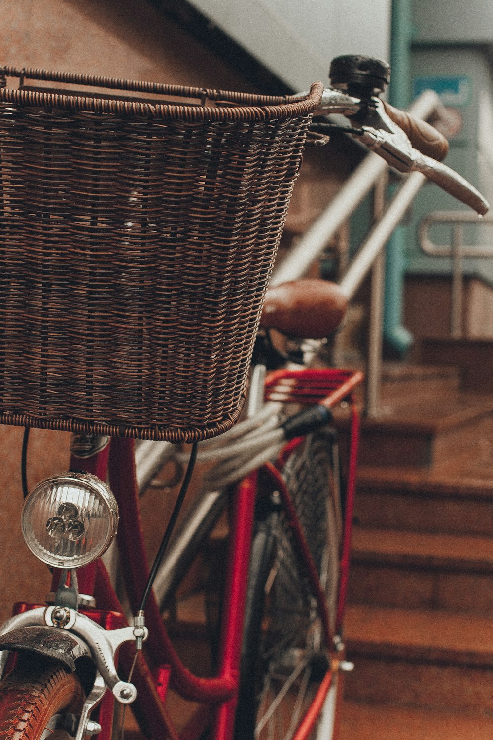 red and brown bicycle beside wall