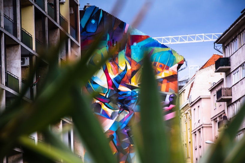 A vibrant street art mural blending colors and shapes in an urban setting
