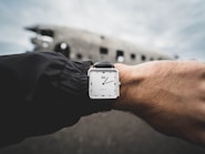 person wearing silver-colored analog watch