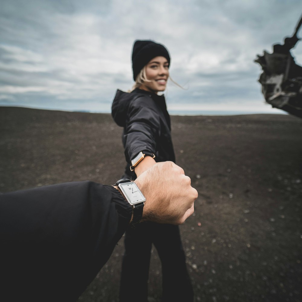 woman holding man's hand