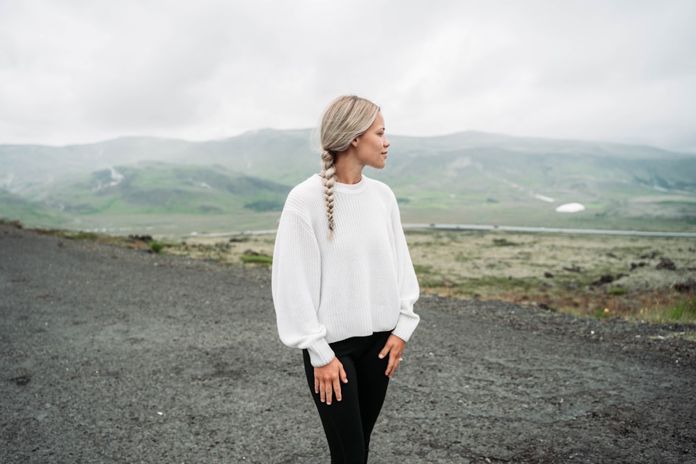 woman standing and looking mountain at daytime