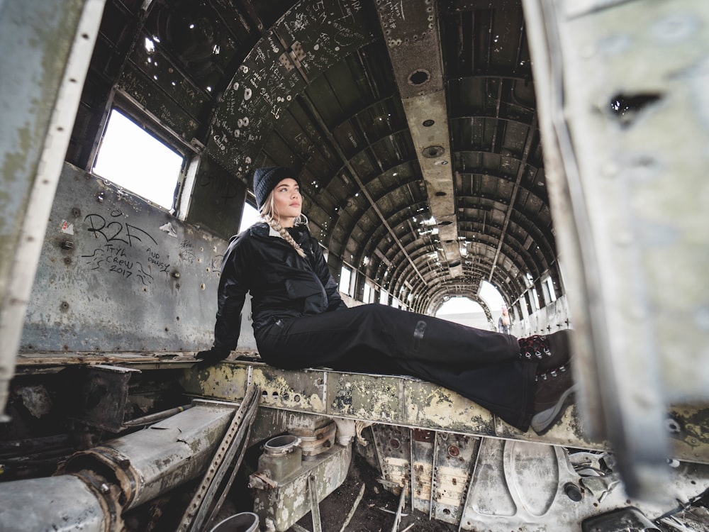 woman sitting inside wrecked vessel