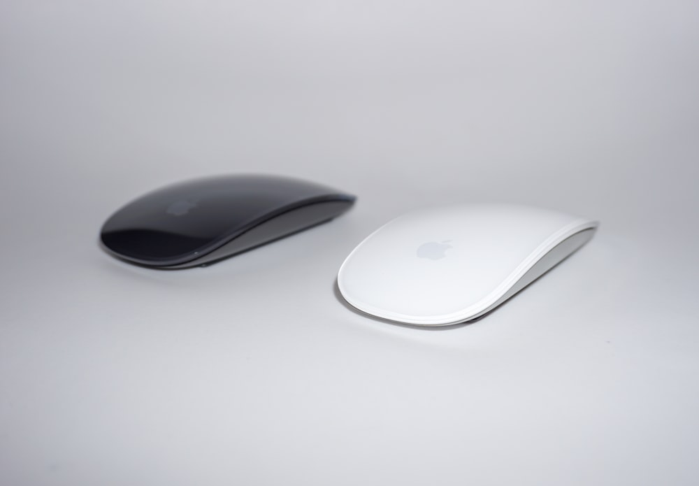two black and white cordless mouse close-up photography