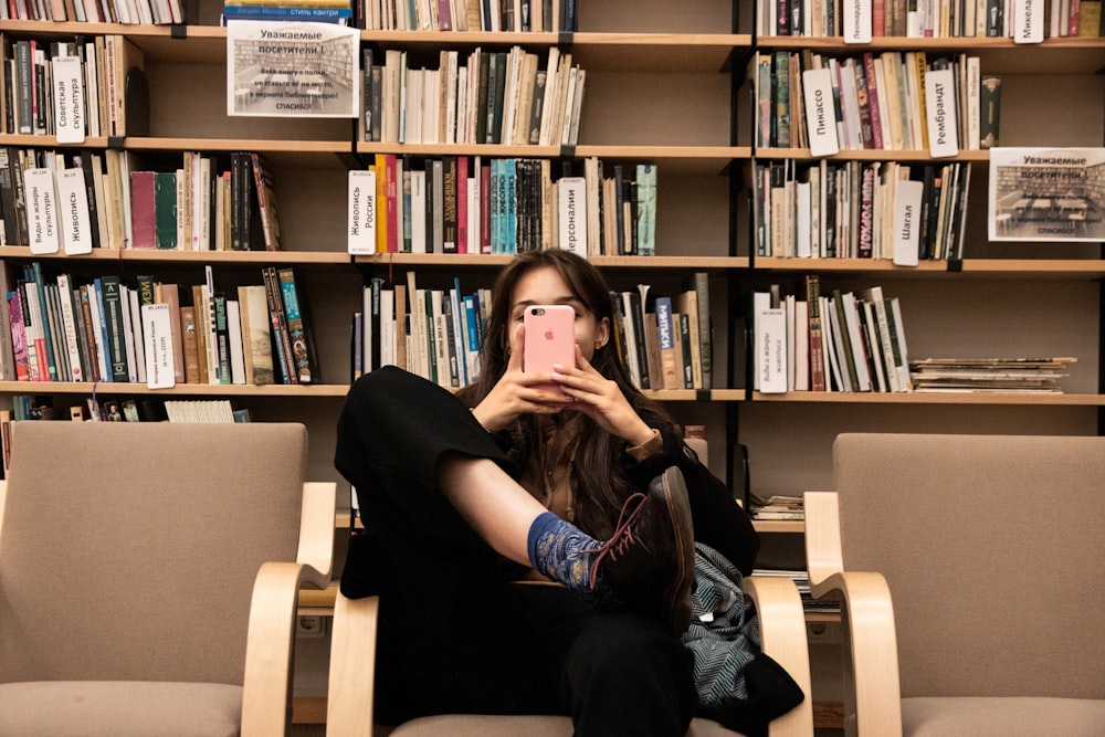 woman wearing black shirt sitting on chair