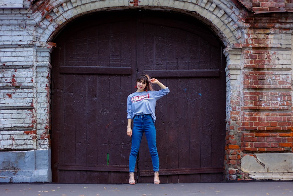 woman standing outside a closed door