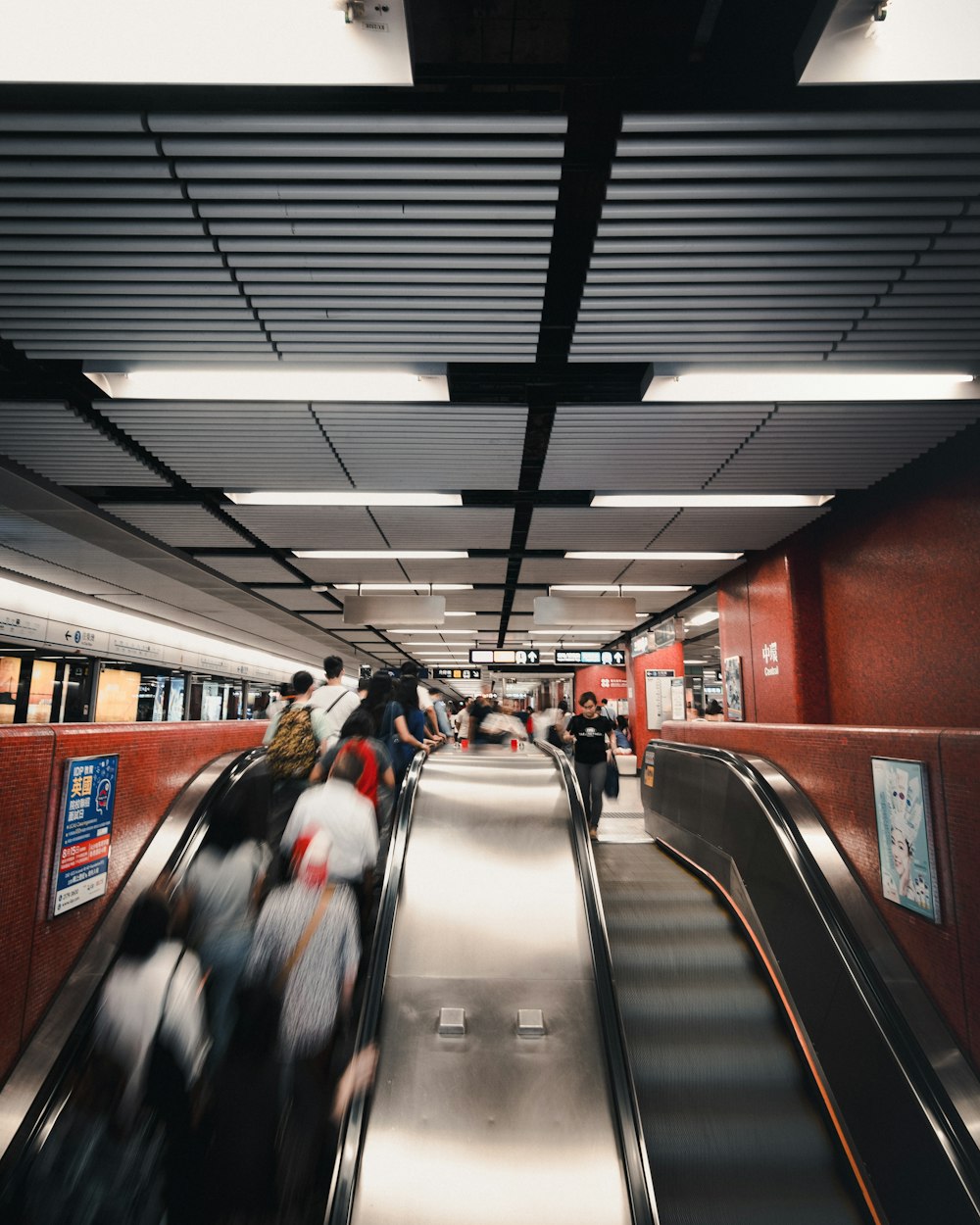 a group of people riding down an escalator