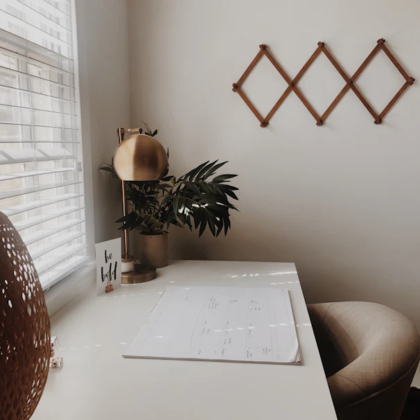 A serene workspace with a minimalist planner and soft beige tones.