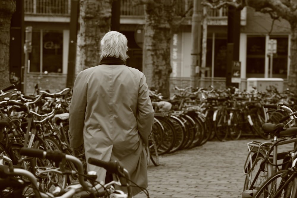 man walking beside parked bikes