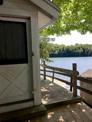 A sturdy deck overlooking a peaceful lake, showcasing smooth woodwork and secure railings.