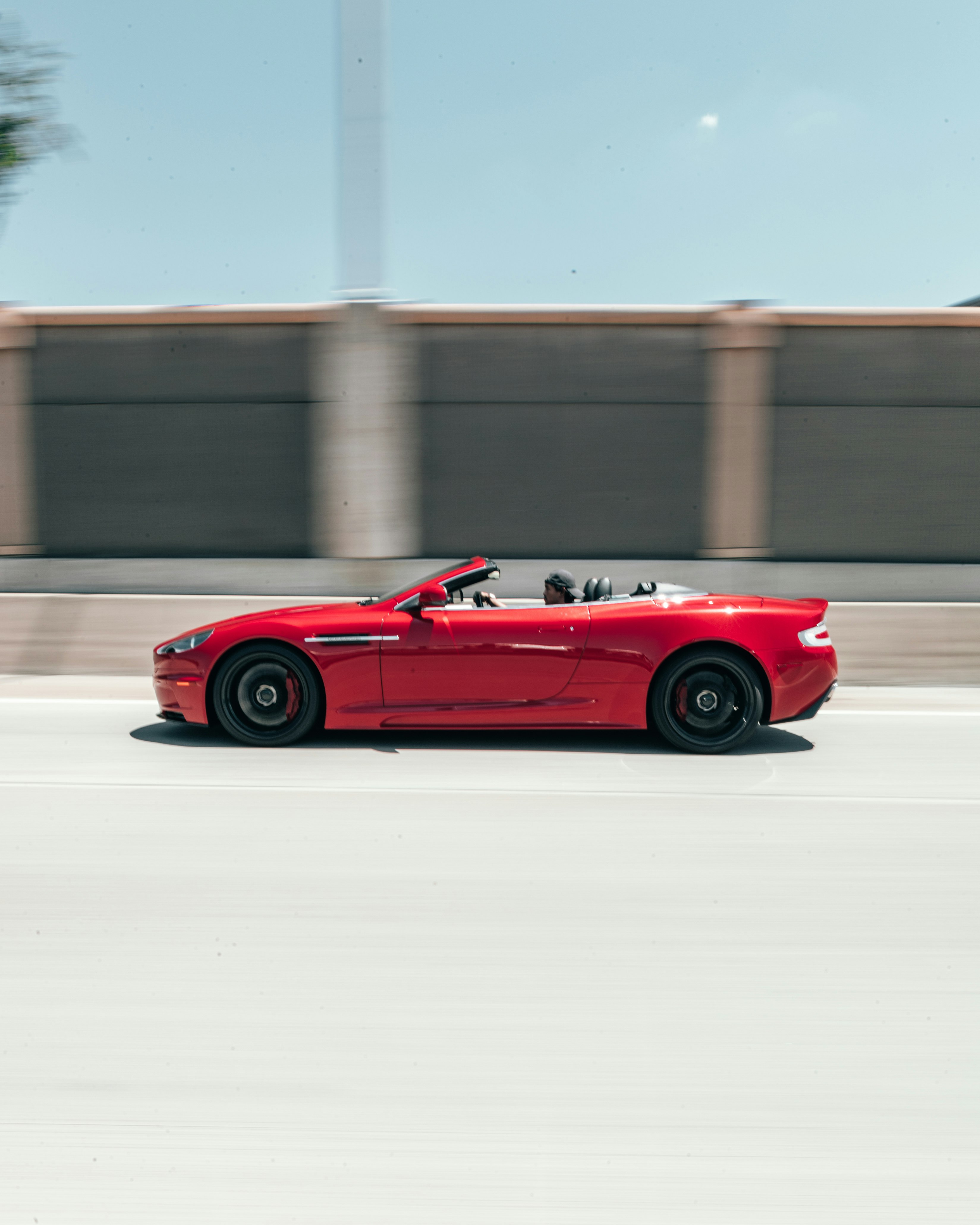 panning photography of red coupe