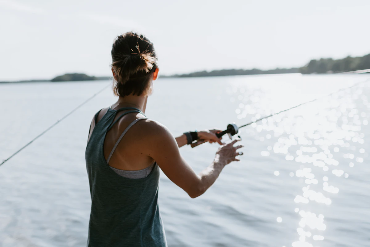A woman casting into a lake