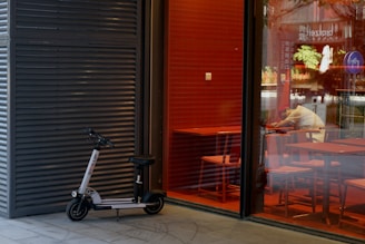 A compact electric scooter folded neatly beside a café table