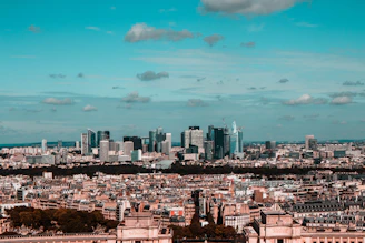 An aerial view of a cityscape highlighting a mix of historic and contemporary architecture.